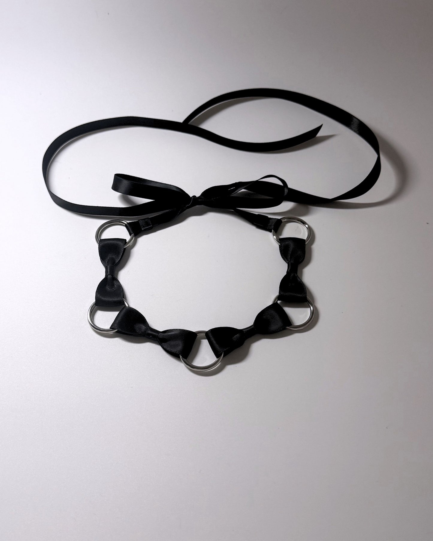 Runaway Bow Headband with Silver O Rings and long satin ties on softly lit background