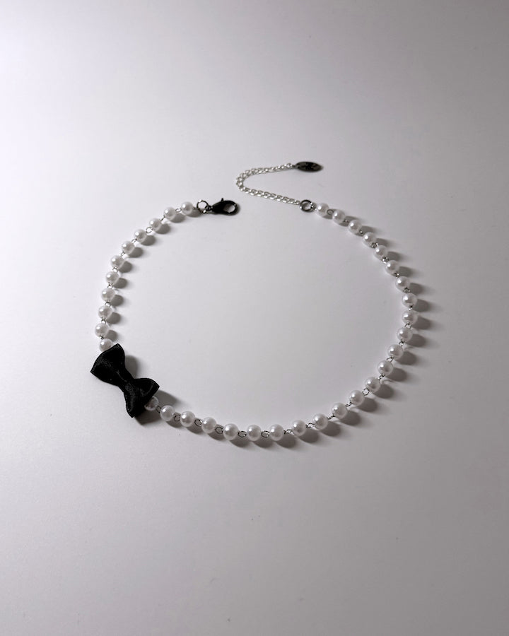 Centerfold Pearl Bow Necklace with black bow off to the side