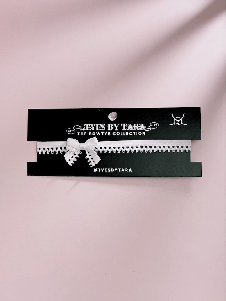 Foxy White Bow Choker on Black Card with Pink Background