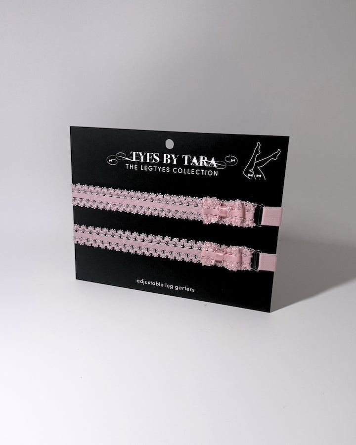 Lady Pink Elastic Leg Garters with soft adjustable straps on gray background on black card