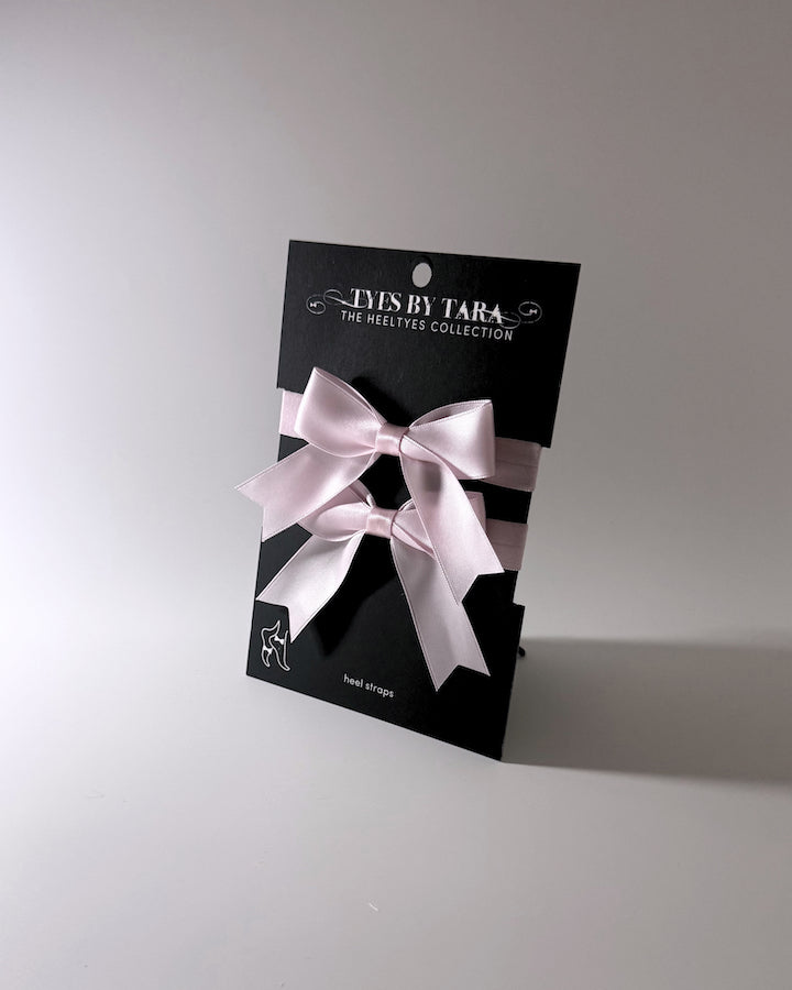 packaging view of pink bow heel straps