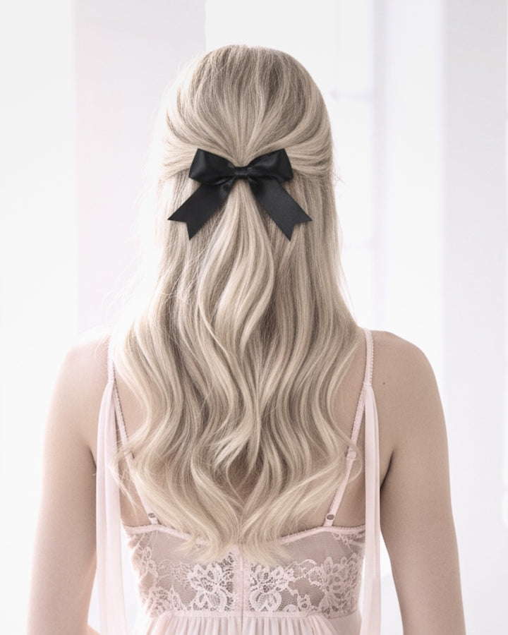 Blonde wearing black bow bombshell hair barrette