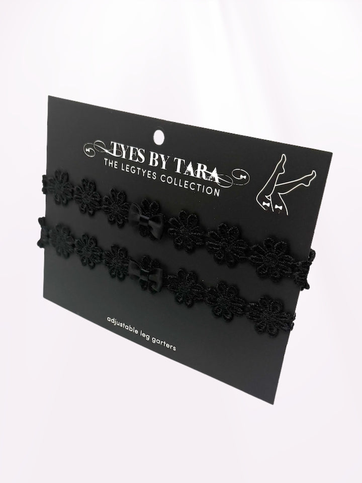 packaging view of black flower bow leg garters