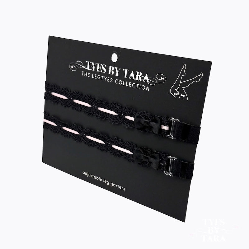 Black lace leg garters on a 'Tyes by Tara' branded card with a white background