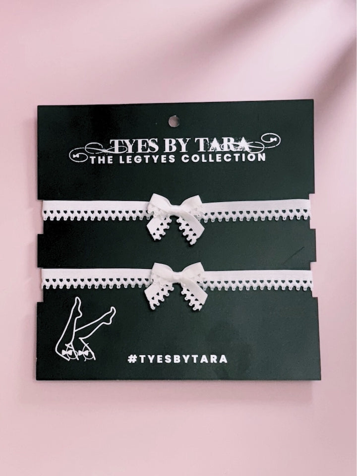 Foxy White Bow Leg Garters on Black Card