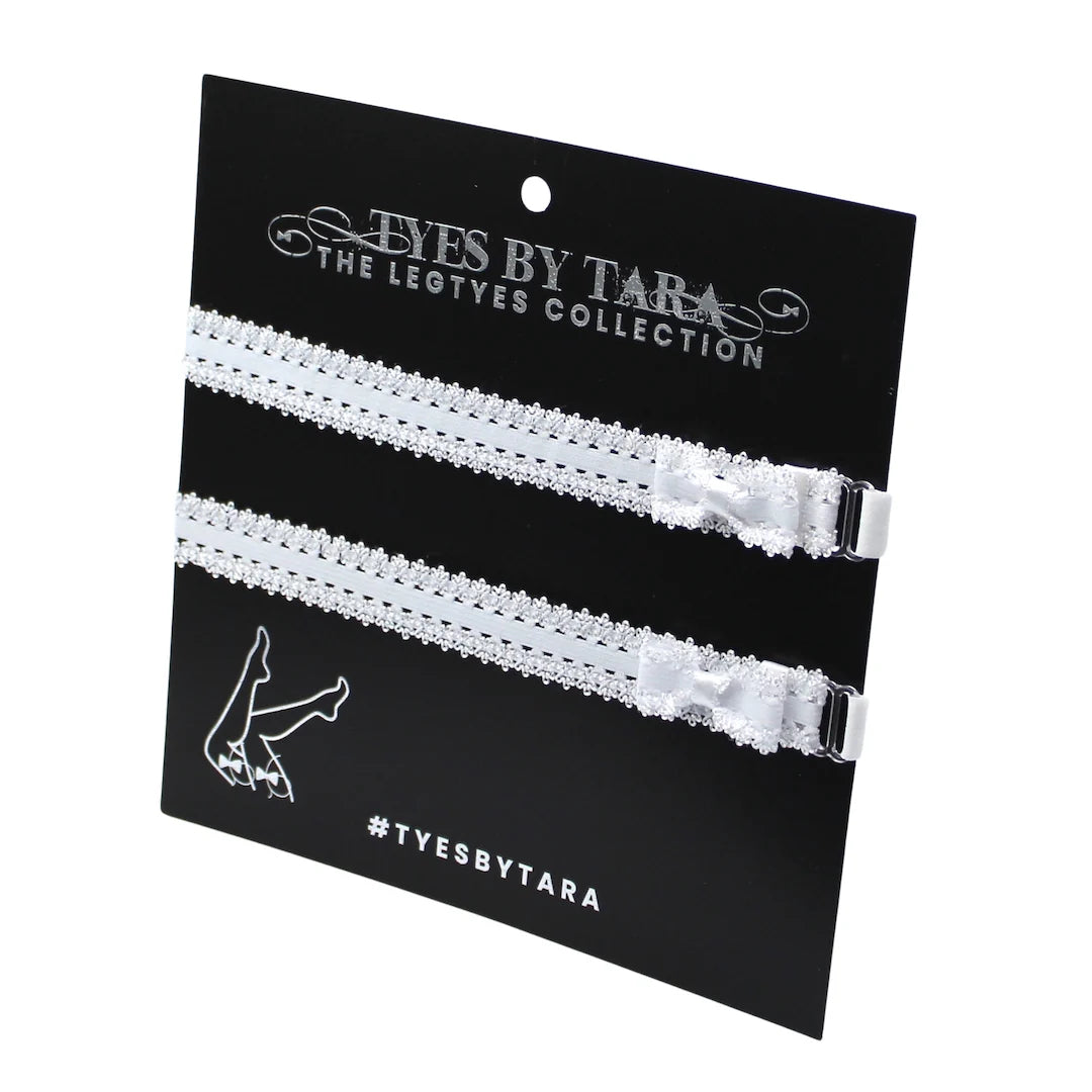 White lace elastic garters on a 'Tyes by Tara' branded card with black background