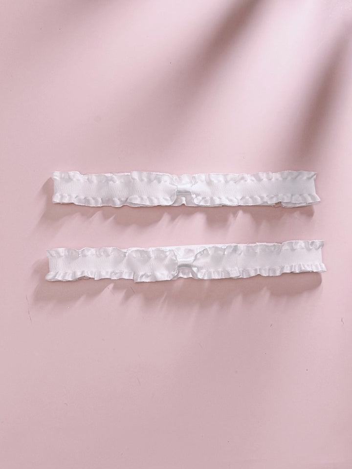 White Ruffled Leg Garters on Pink Background