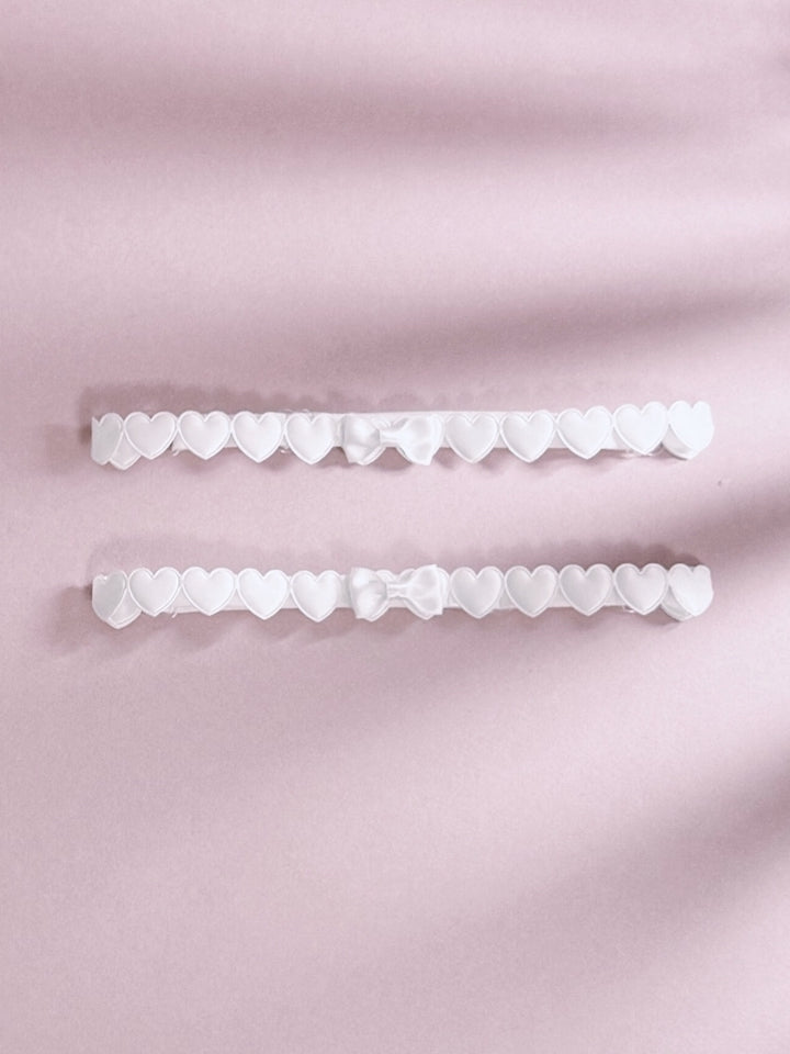 White Heart Leg Garters On Pink Background