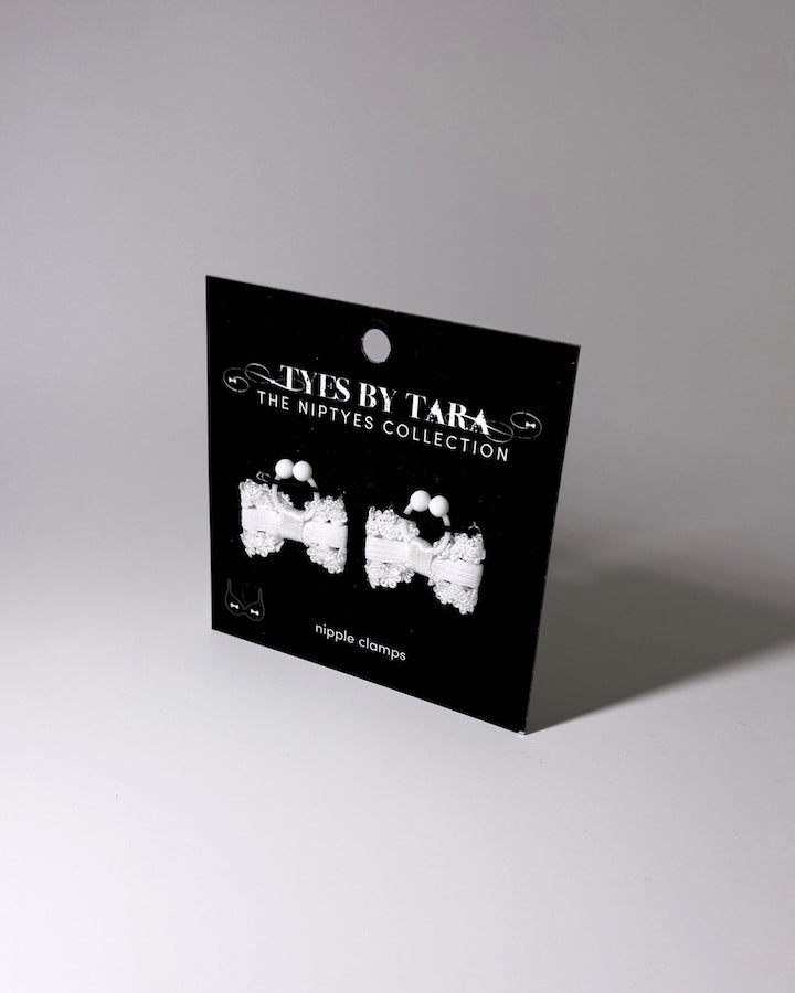 Lady White bow nipple clamps displayed on a retail black card