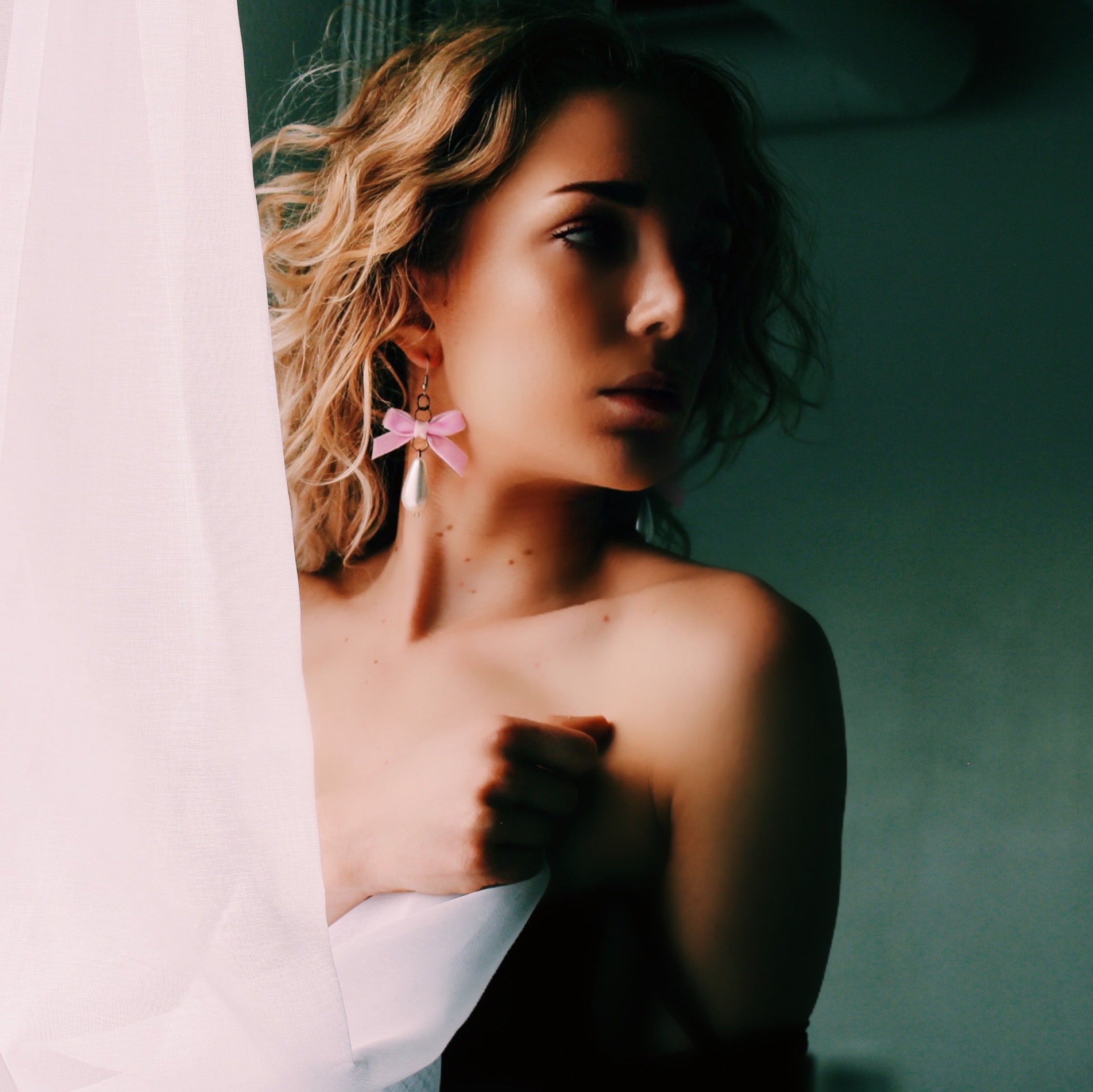 Pink Velvet Bow Pearl Earrings on Model in Boudoir