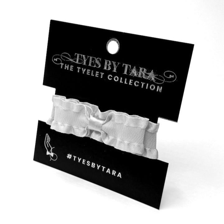 White Ruffled Bow Bracelet on Black Card