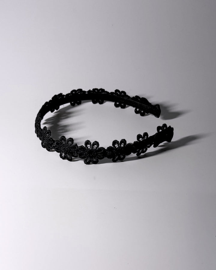Blossom Black Flower Bow Headband with Satin Bows Side View with dramatic lighting