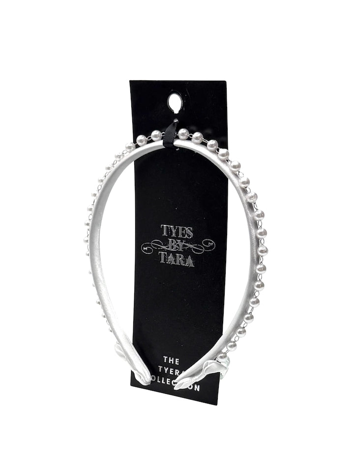 white pearl headband on black card