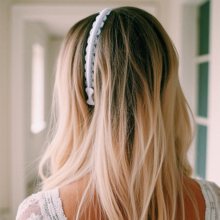 Beautiful blonde wearing chantilly white lace headband in wedding dress facing away showing the bow at the end
