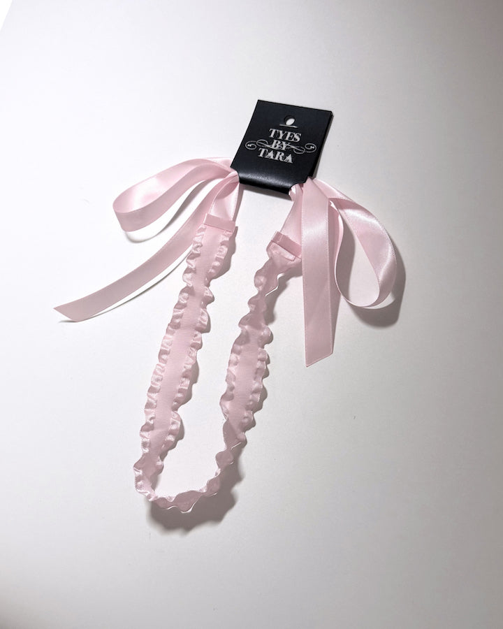 Pink Ruffled Headband with long pink satin ties on black card