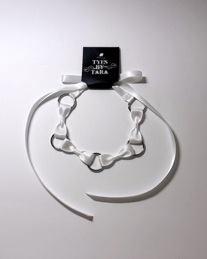 White Bow Headband with Silver O Rings and retail tag attached