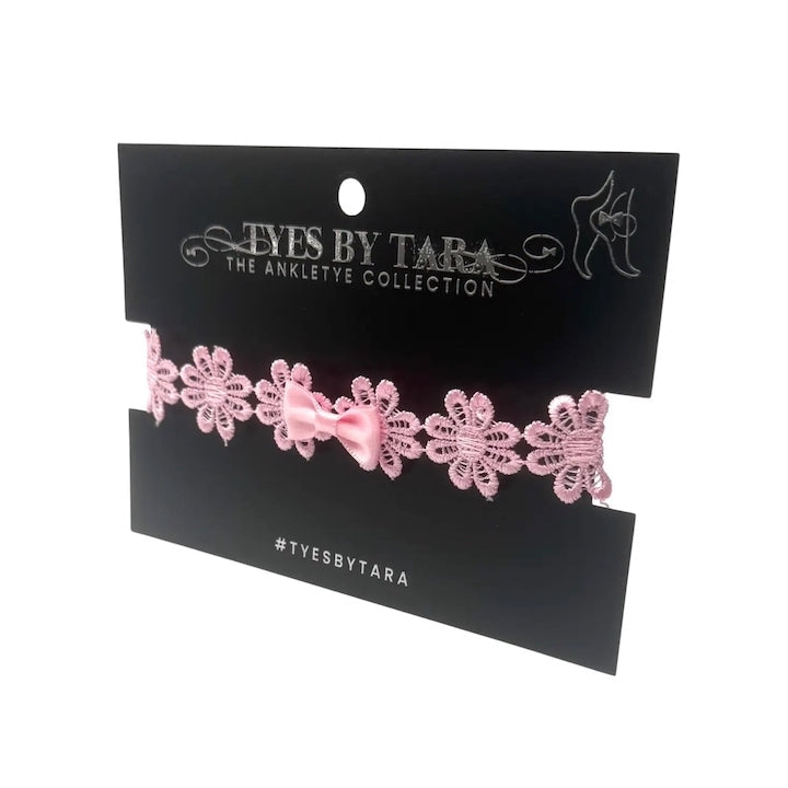 pink bow anklet on black card