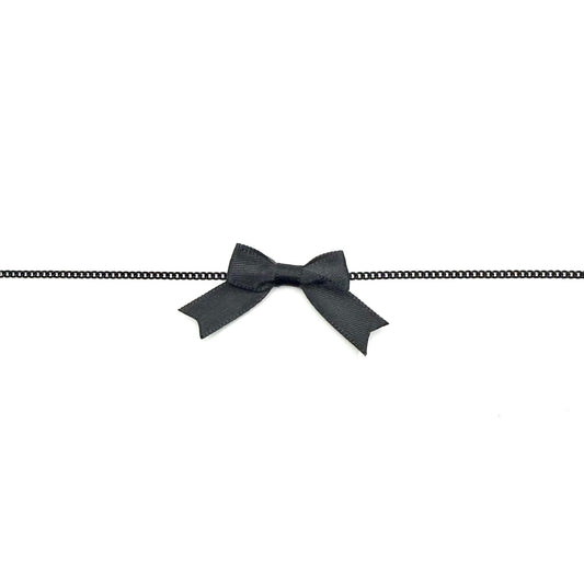 Black bowtie necklace on a white background