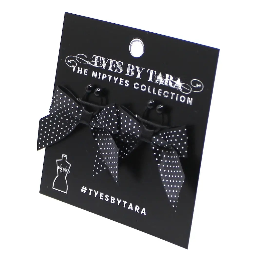 black pinup nipple clamps on black card on white background