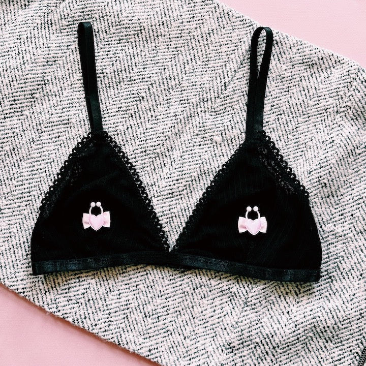 pink heart nipple clamps on black bra