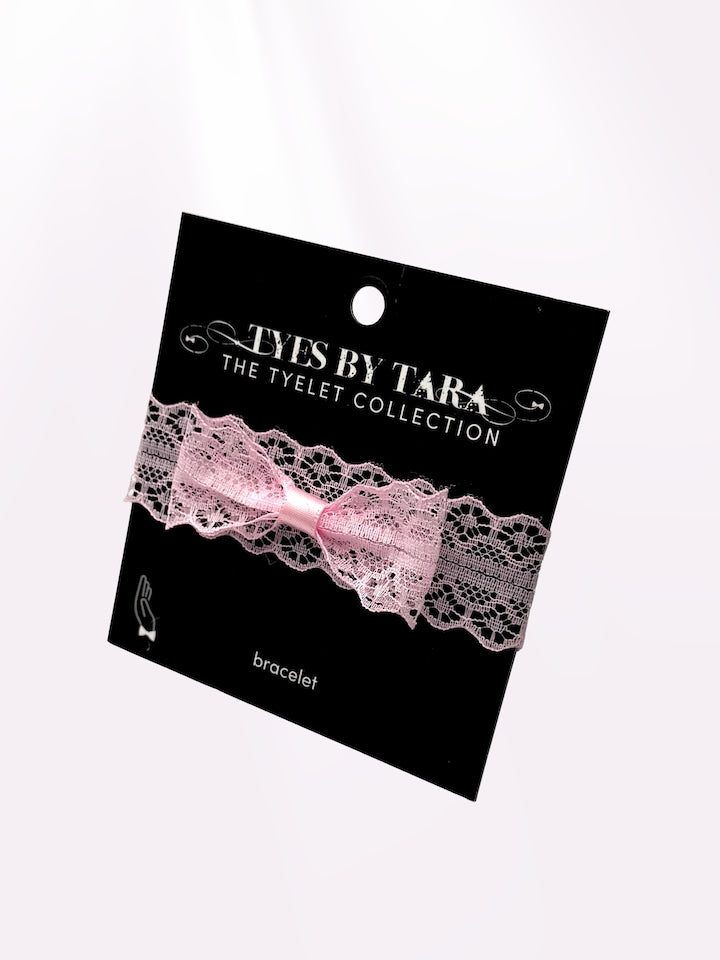 light pink lace bow bracelet on black card