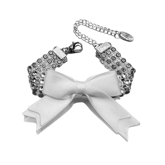 sparkly white bow bracelet on white background