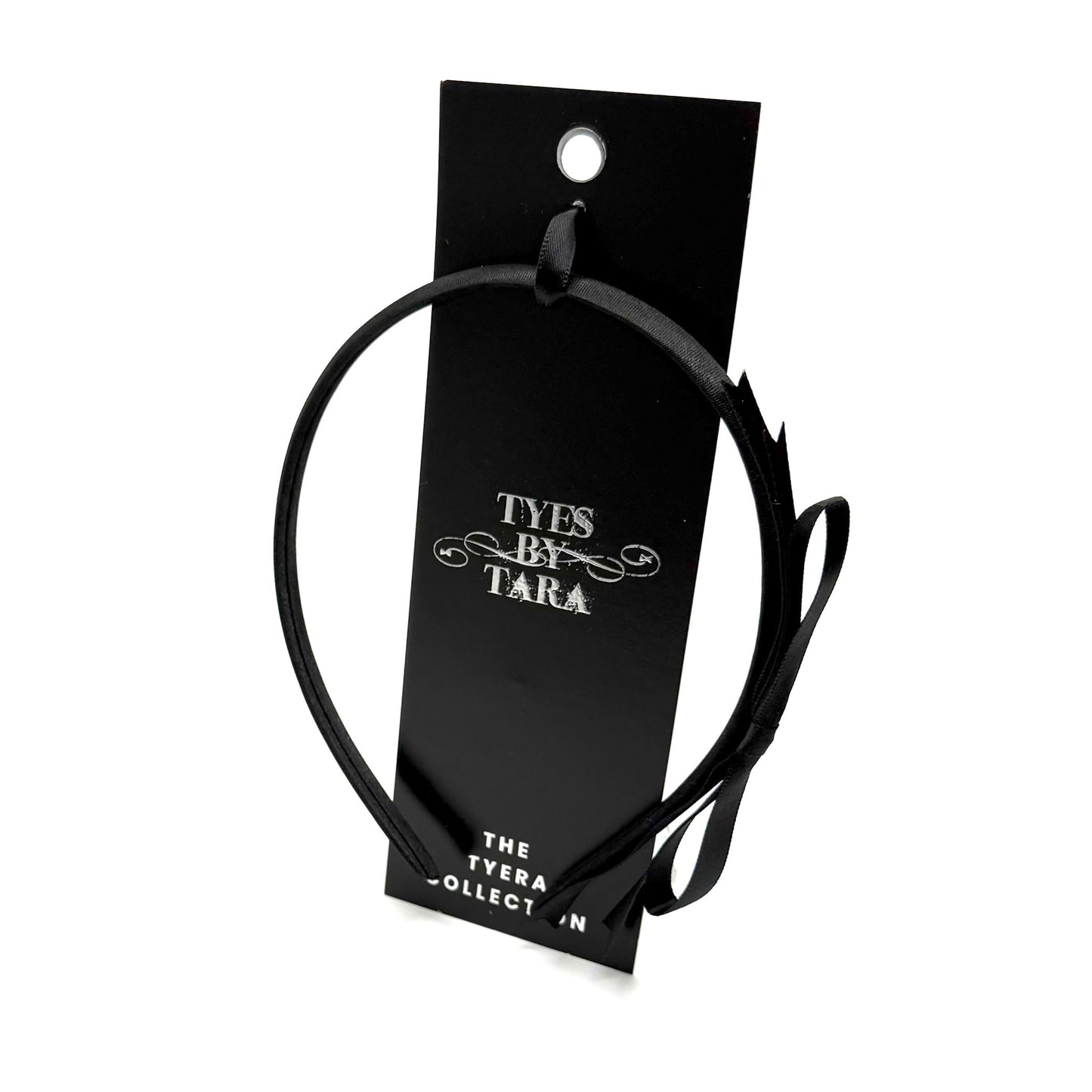Black headband on a 'Tyes by Tara' branded card against a white background