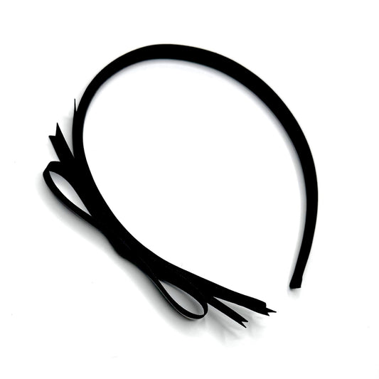 Black Satin Bow Headband on White Background with wispy bow off to the side