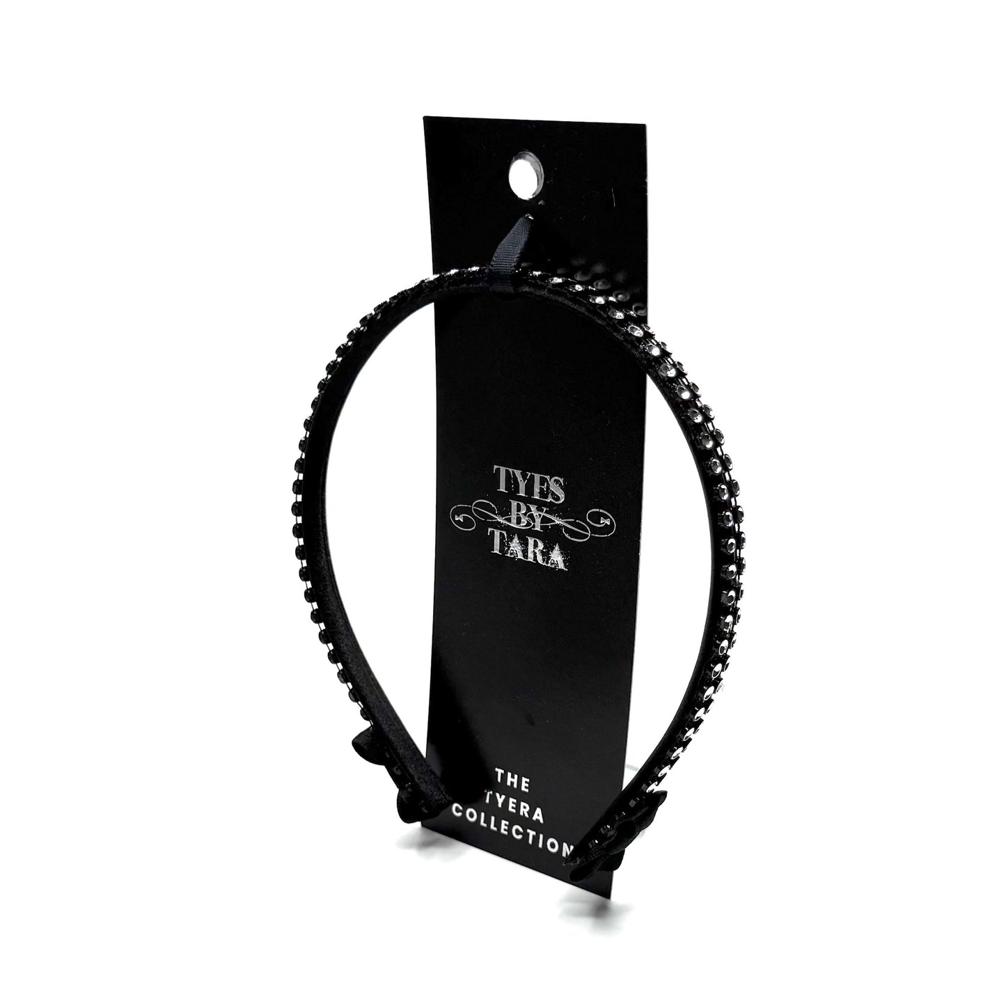 Black hairband with black and silver rhinestone mesh with black bows at the end on white background Packaging View