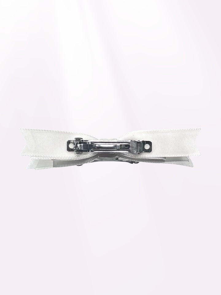 back view of enchantress white satin hair bow barrertte