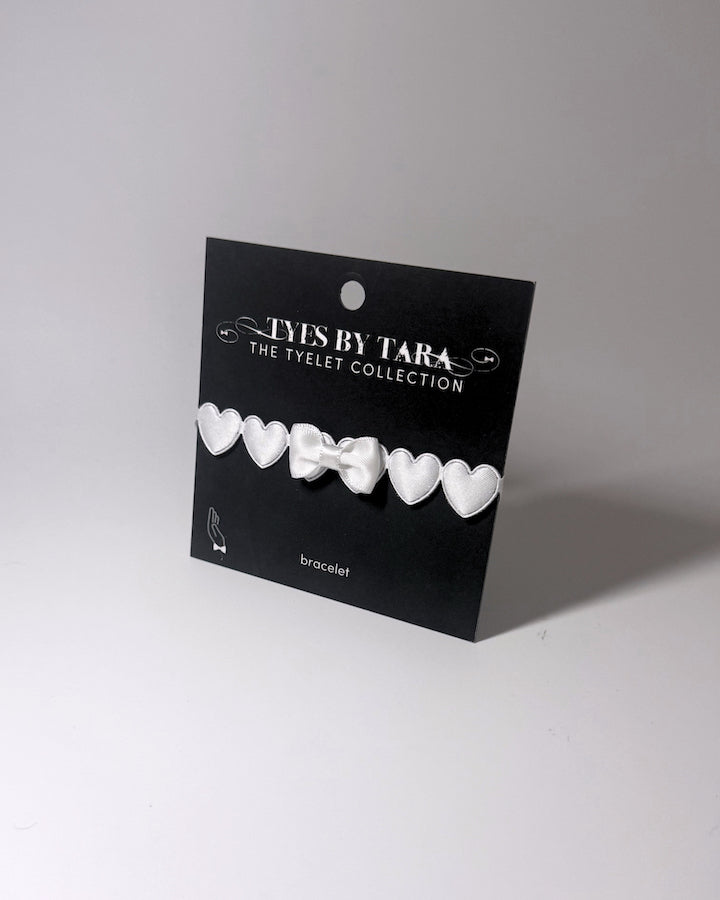 White Heart Bow Bracelet on Black Card