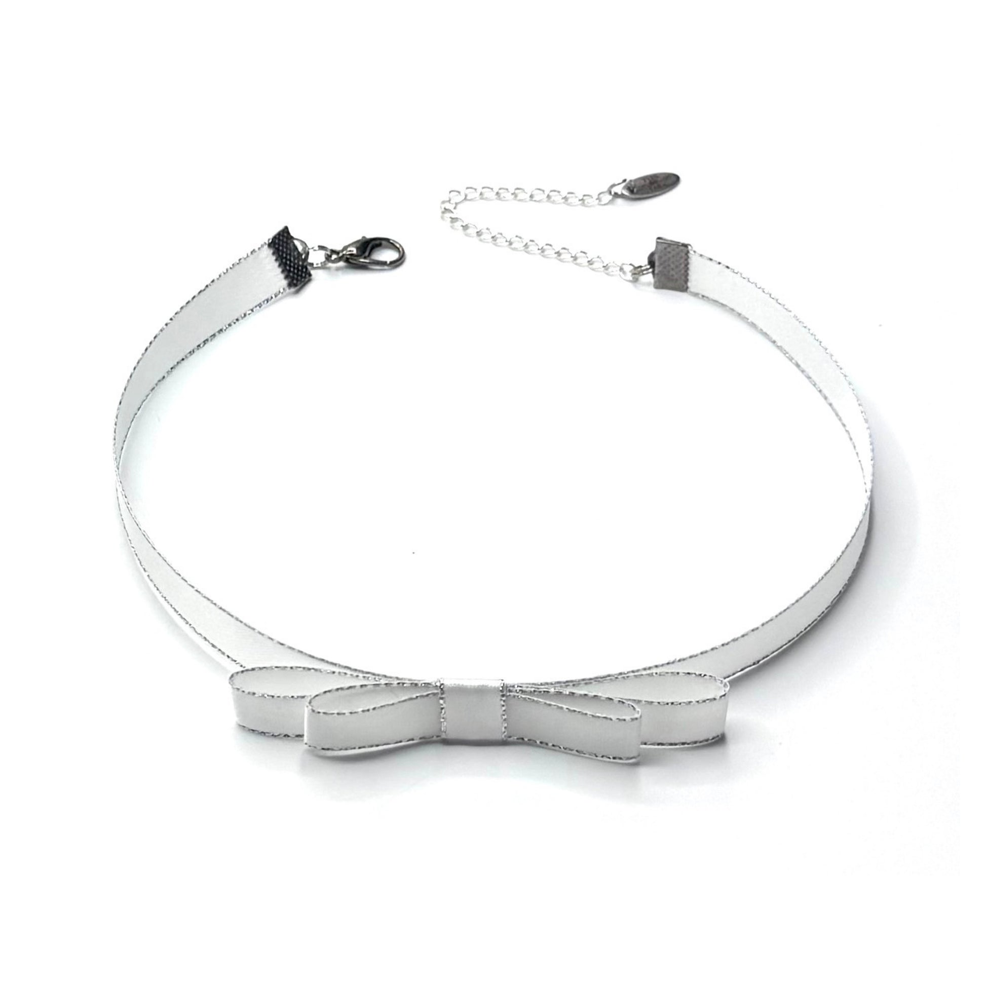 Silver bow-shaped choker necklace on a white background