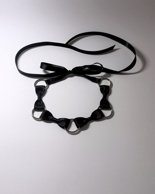 Runaway Bow Headband with Silver O Rings and long satin ties on softly lit background