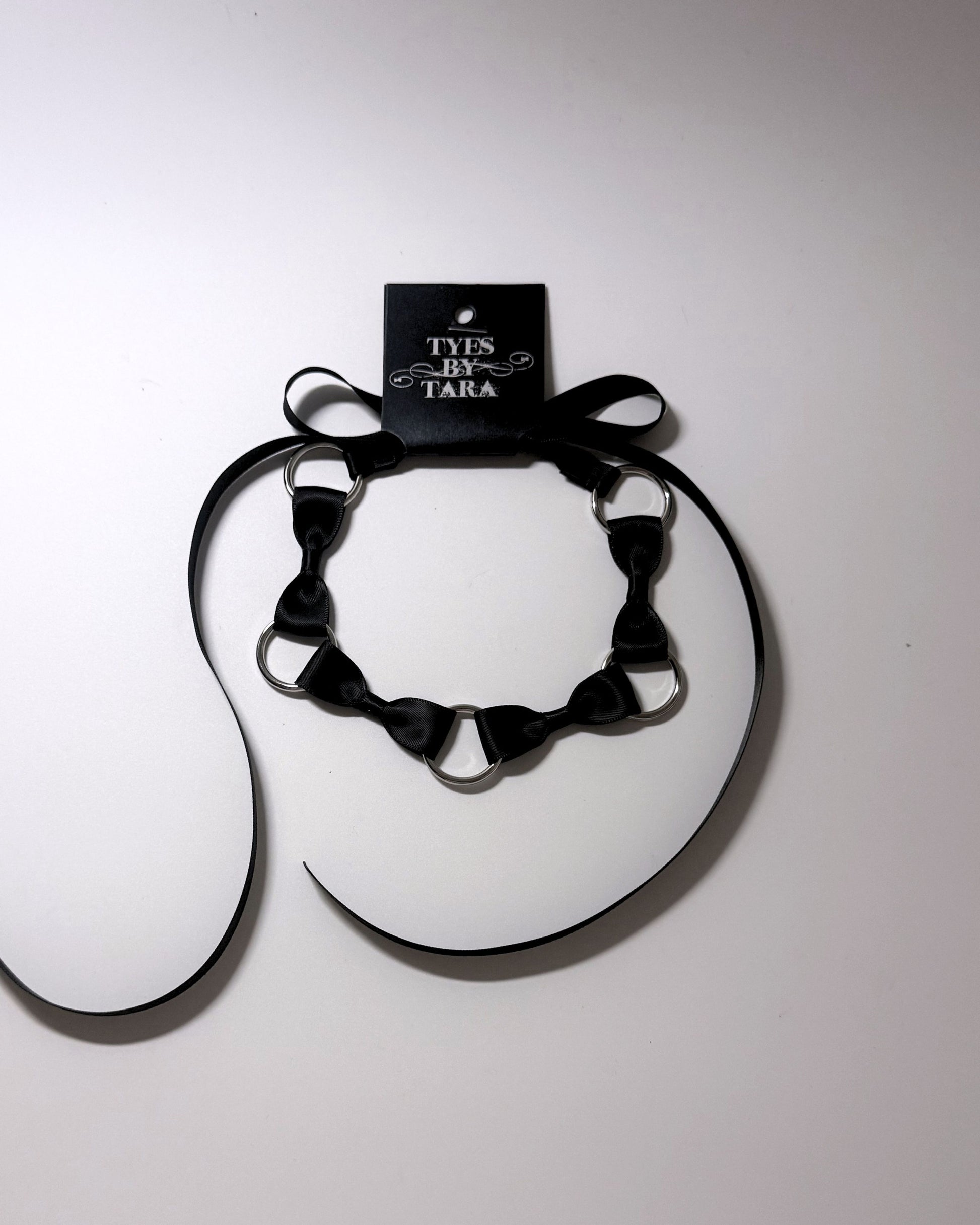 Runaway Bow Headband with retail tag attached on softly lit background