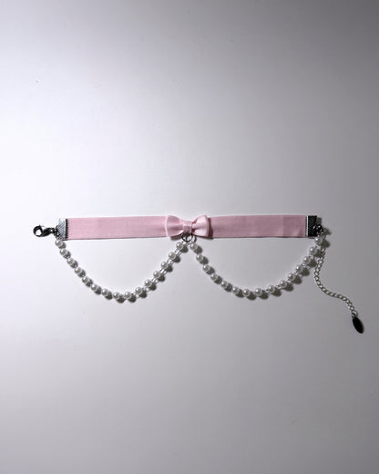 Light Pink Bow Anklet with faux pearl chain drape on light background with pretty shadows