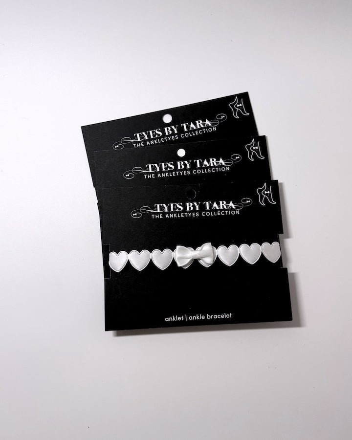 Sweetheart White Heart Bow Anklet three pack on black retail cards