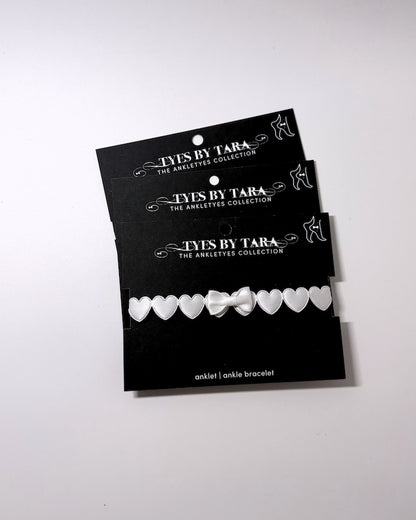 Sweetheart White Heart Bow Anklet three pack on black retail cards