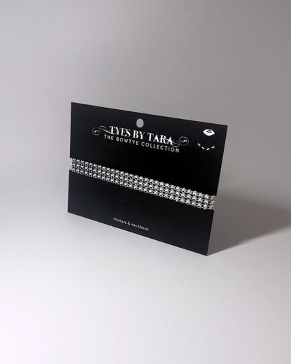 Vixen White Sparkly Choker displayed on a black card