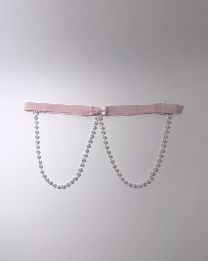Centerfold Pink Bow Pearl Belt on softly lit background