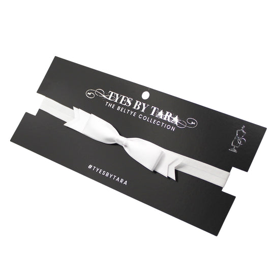 White bow belt On a 'Tyes by Tara' branded card on a white background