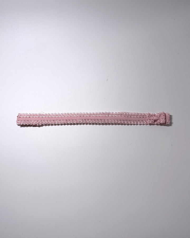 Elastic pink bow belt displayed on gray background