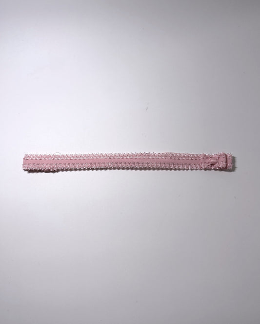 Elastic pink bow belt displayed on gray background