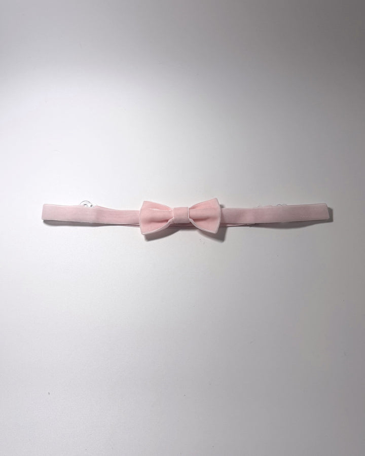 A Pink Velvet Bow Belt on a softly lit surface