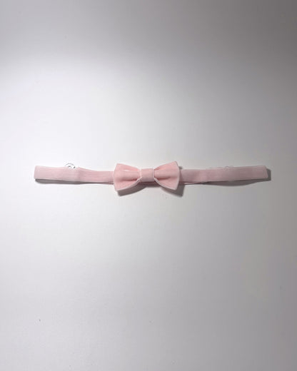 A Pink Velvet Bow Belt on a softly lit surface