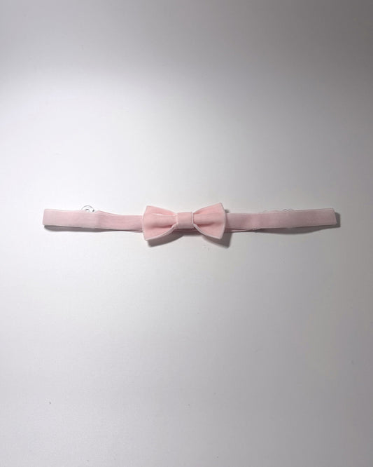 A Pink Velvet Bow Belt on a softly lit surface