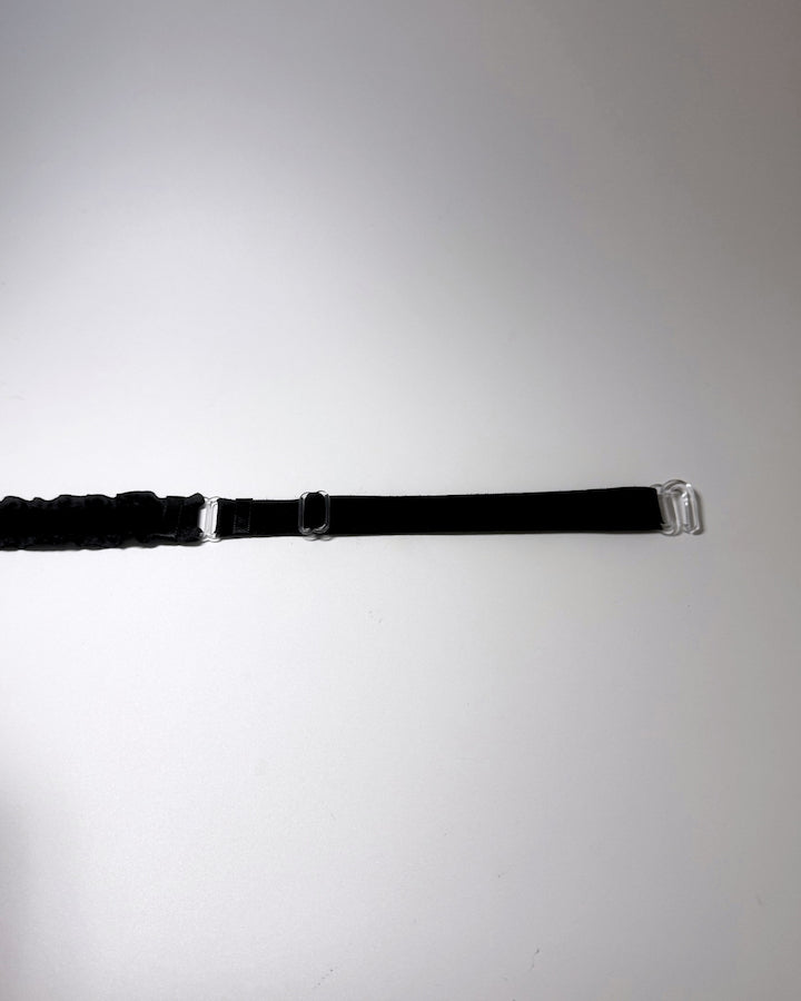 Black Ruffled Bow Belt on softly lit surface