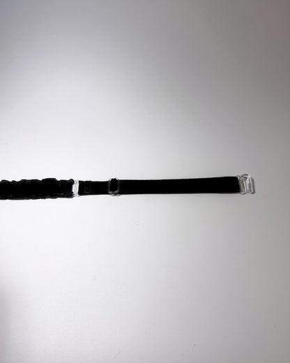 Black Ruffled Bow Belt on softly lit surface