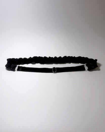 Black Ruffled Bow Belt on softly lit surface showing the elastic adjustable strap