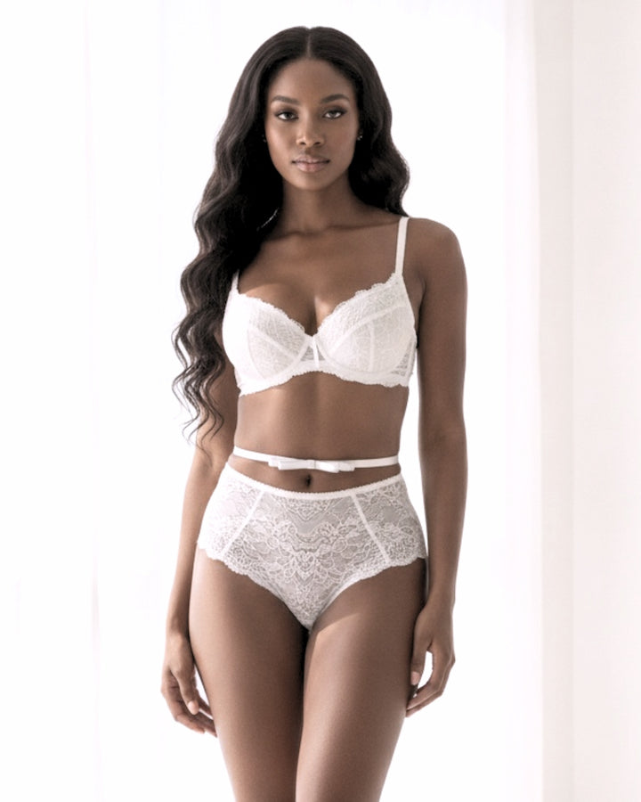White Queen Bow Belt on model in white lingerie in an elegant white boudoir