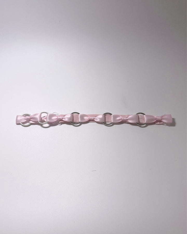 Runaway Pink Bow Belt on softly lit surface